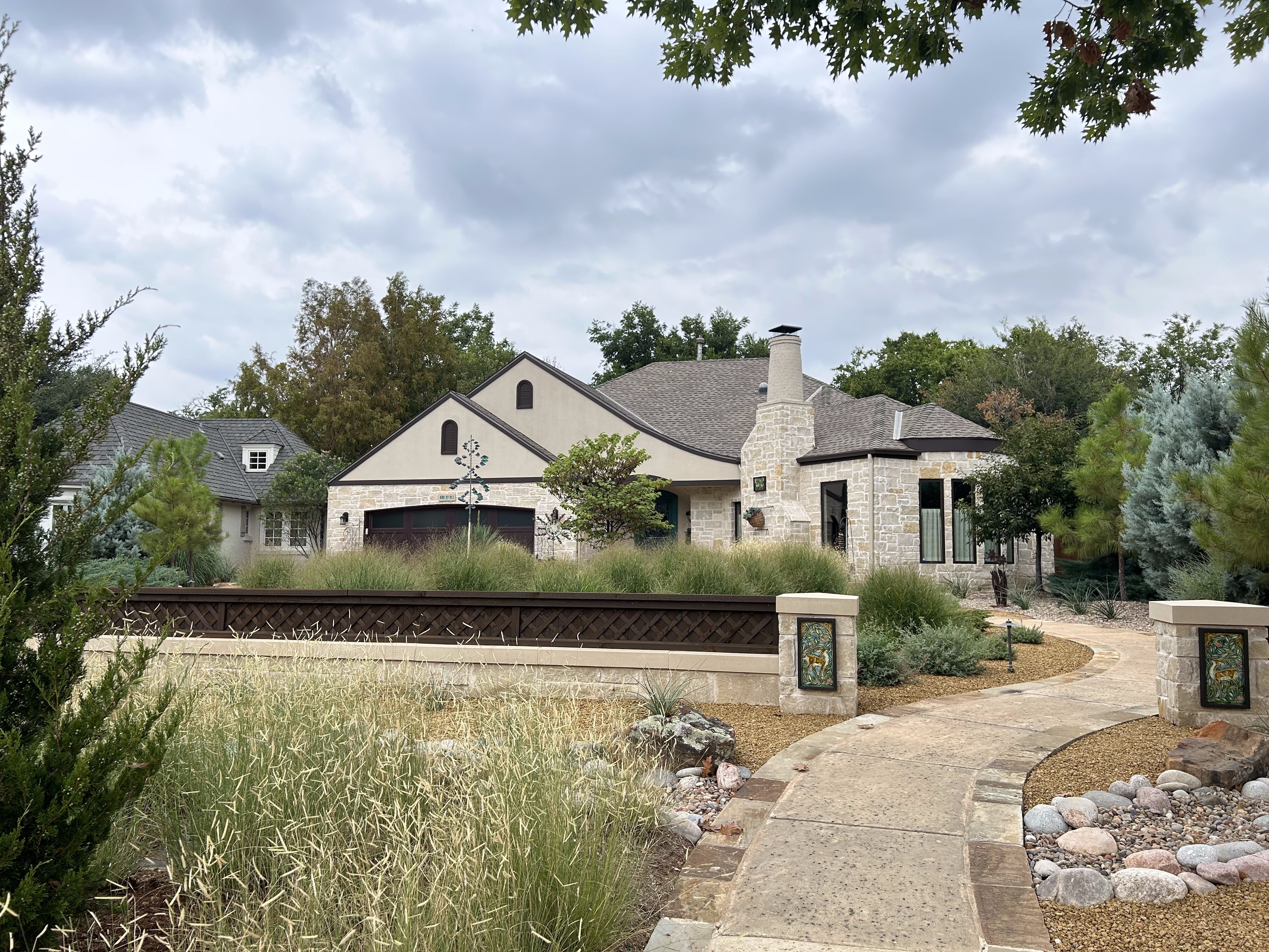 Crushed granite walkway and flagstone pavers with grasses and plants