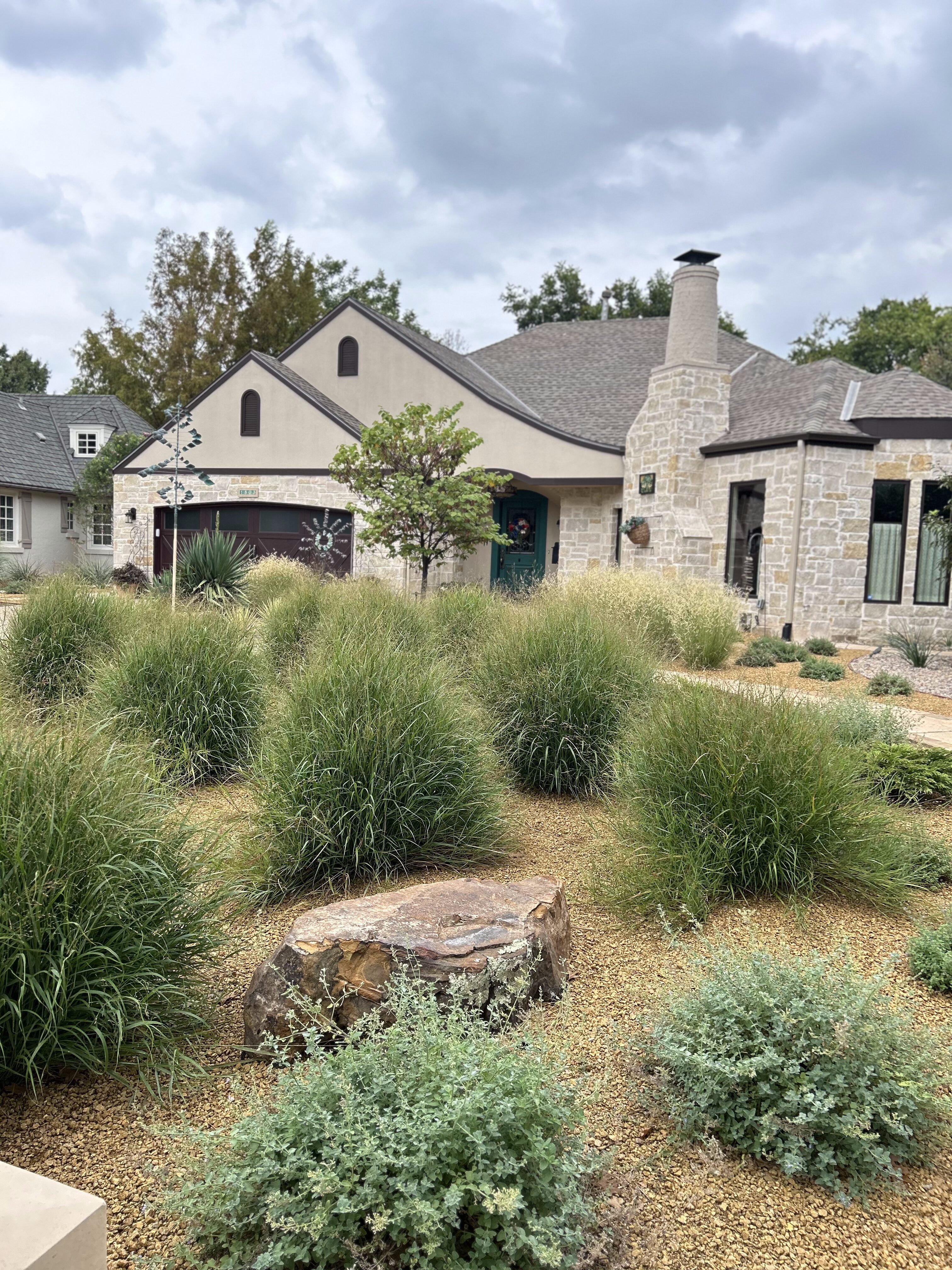 Crushed granite and flagstone pavers with grasses and plants