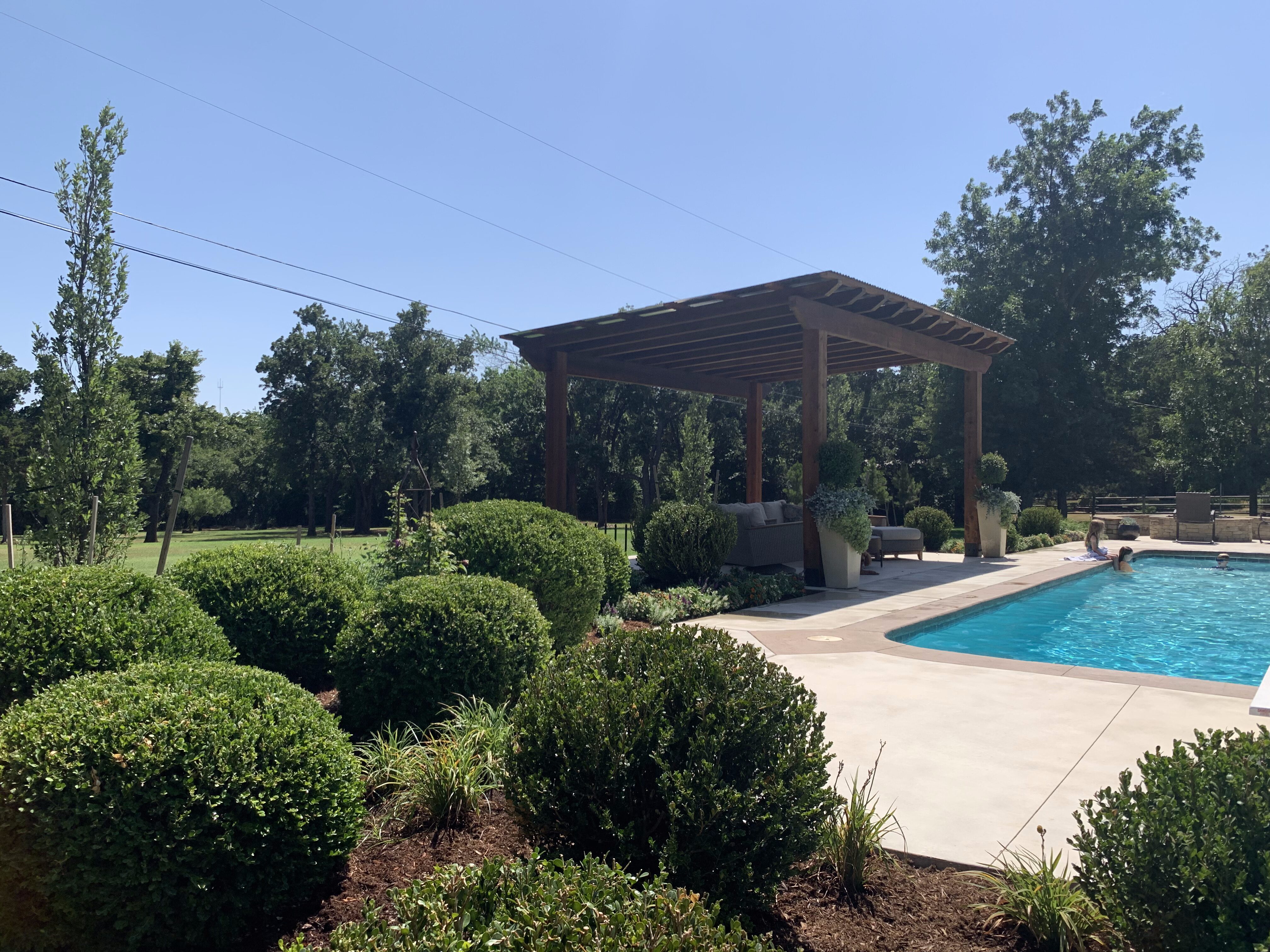 Pergola and pool with boxwood greenery