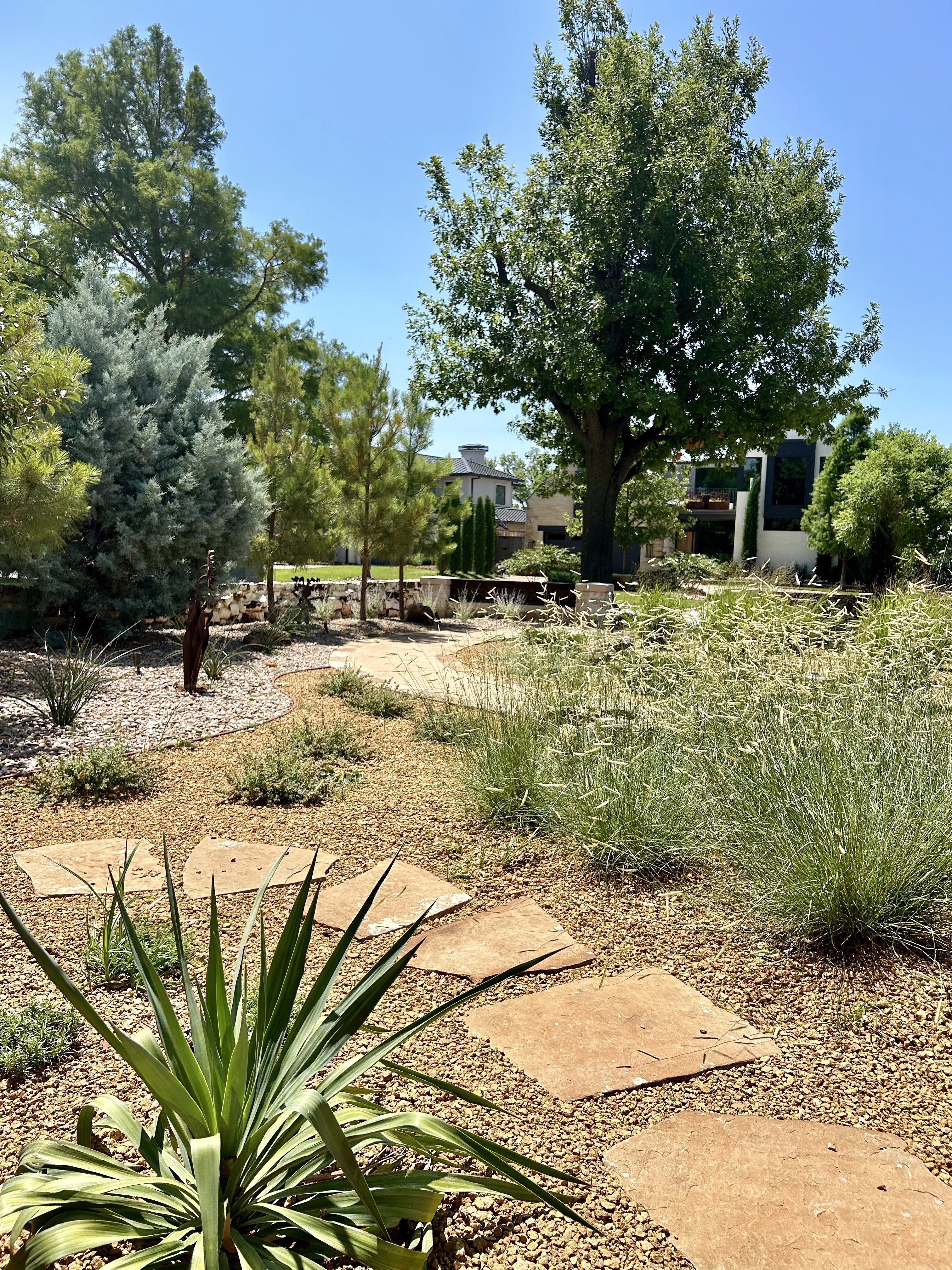 Crushed granite and flagstone pavers with grasses and plants