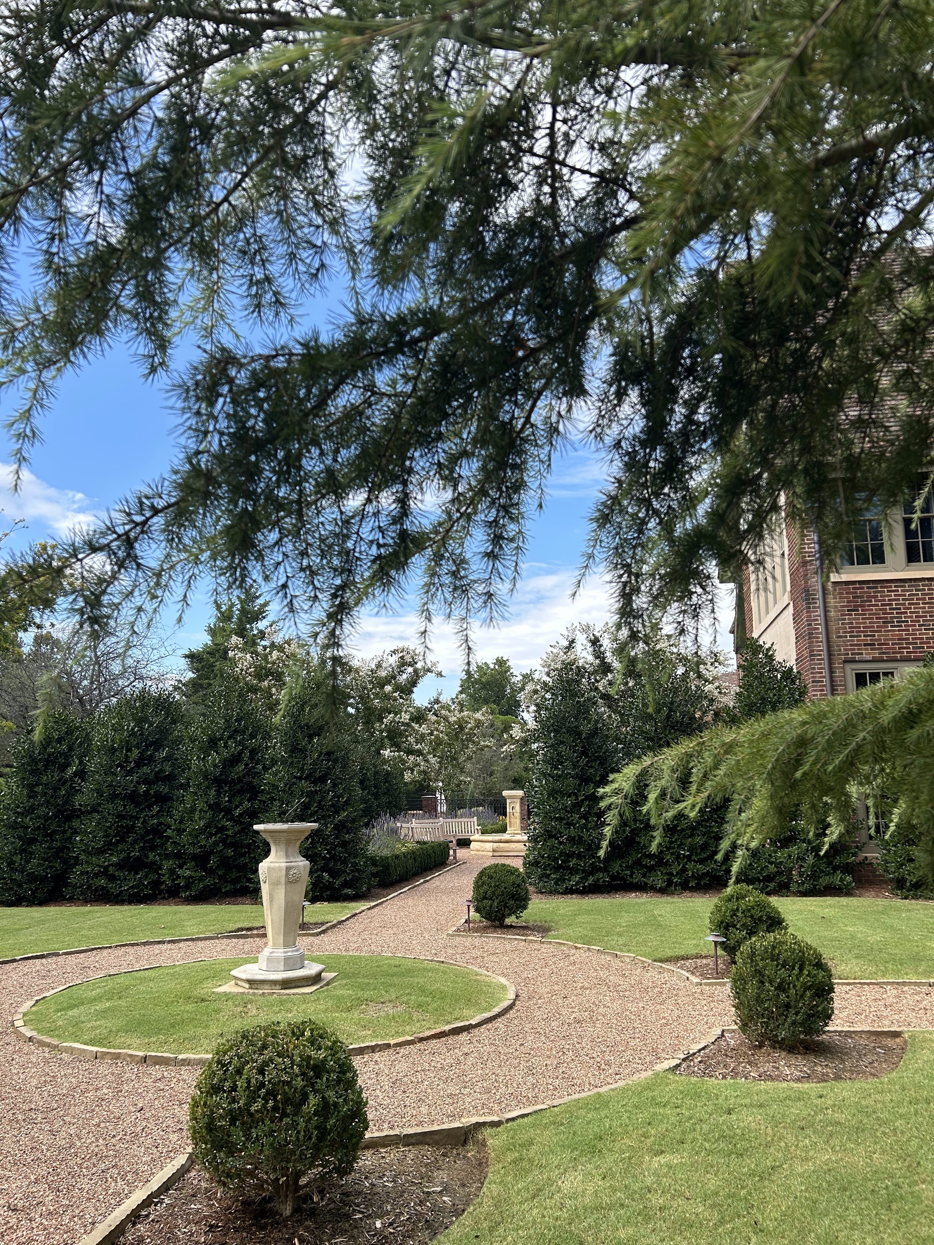 Nichols Hills English garden-inspired gravel walkway with fountain