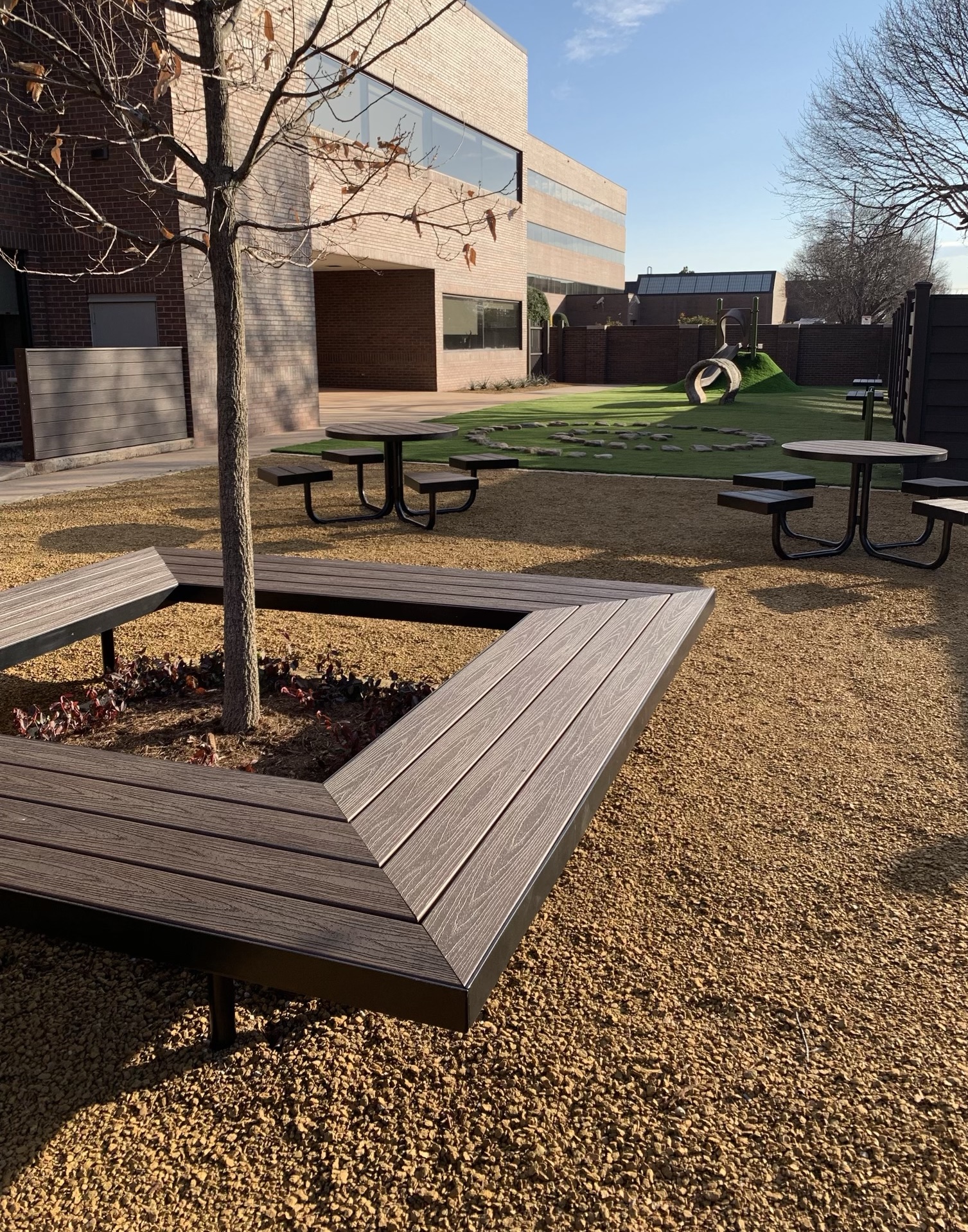 Playground with artificial grass and courtyard area