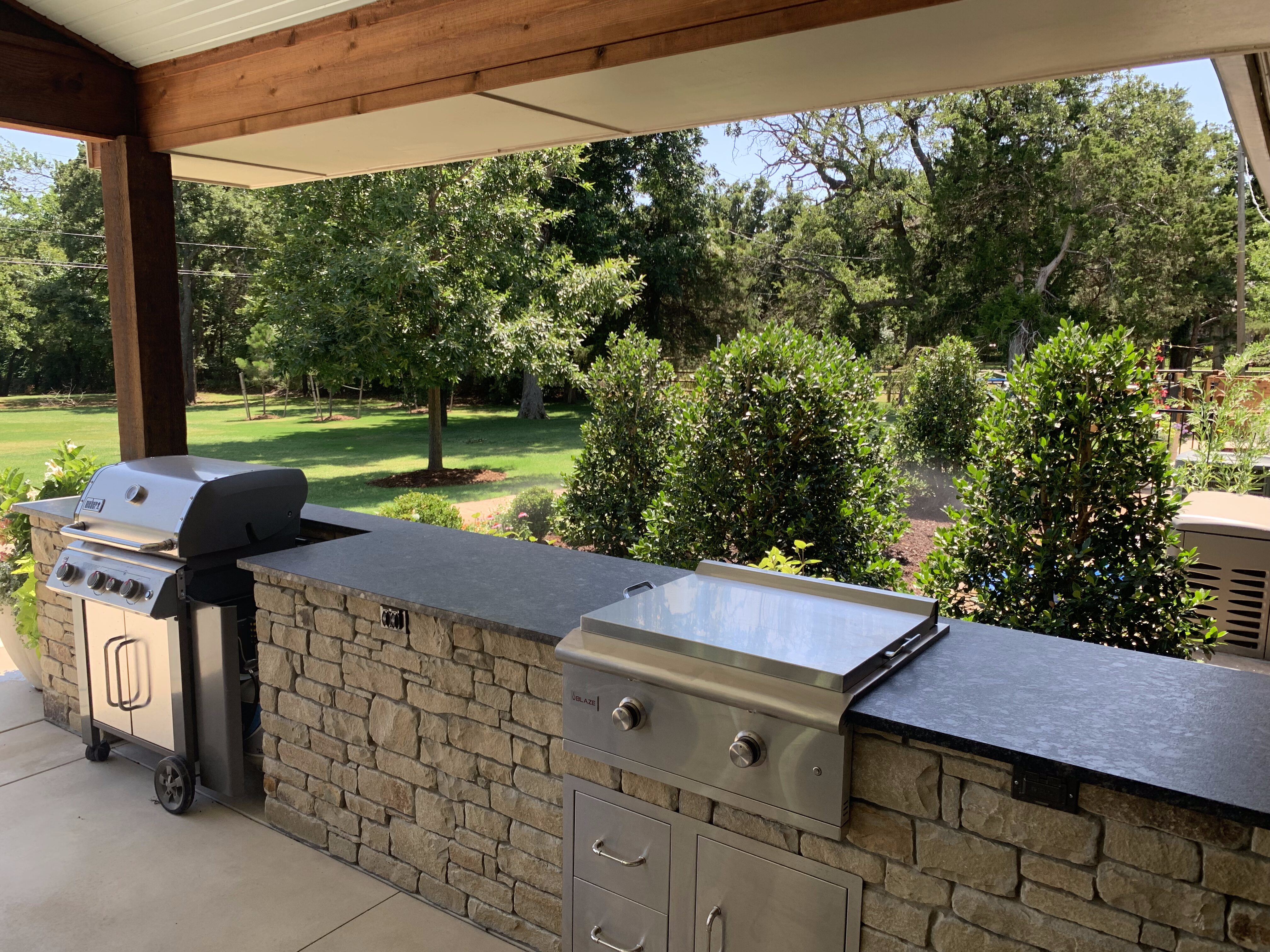 Outdoor kitchen with landscaping around