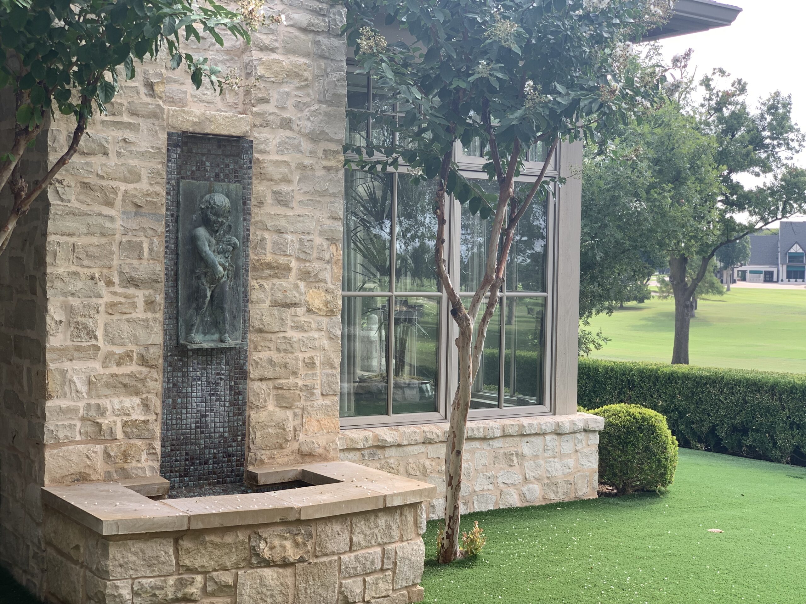 Close-up of landscaping fountain and shrubs