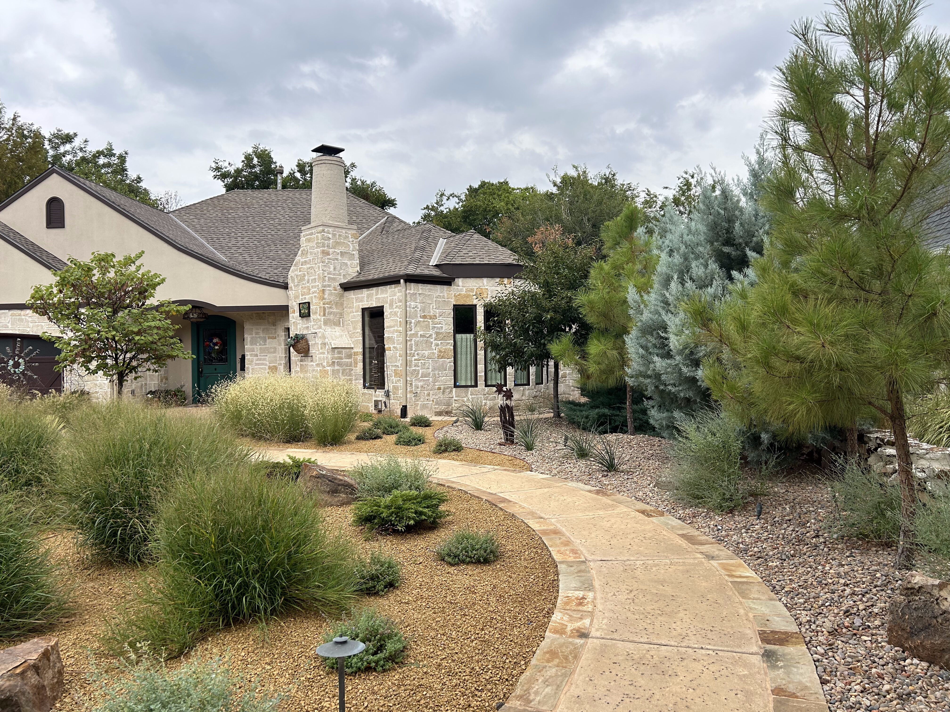 Landscape design with front walkway and grasses